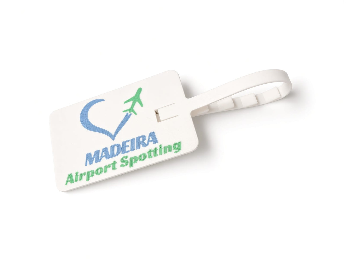 A white plastic luggage tag with a loop handle, featuring a blue and green heart-shaped airplane logo and the text 'MADEIRA Airport Spotting' on a white background.